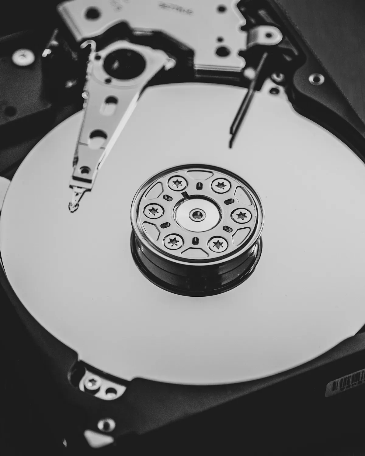 The platter and read-write arm inside an open hard disk drive